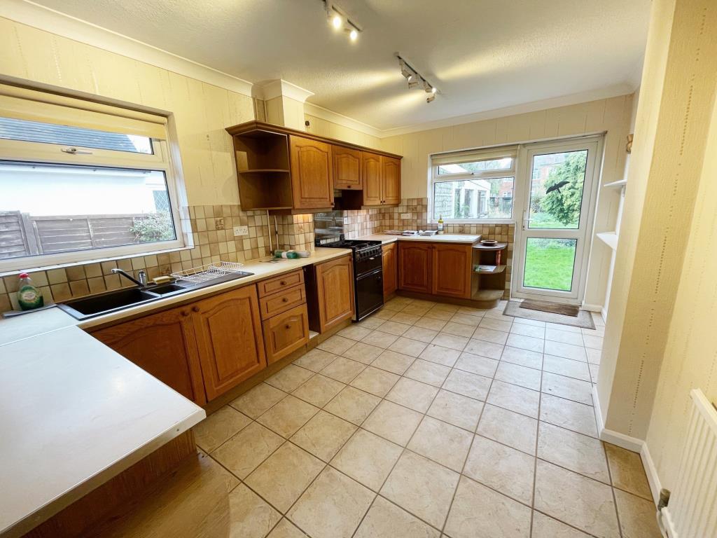 Lot: 63 - A DETACHED THREE-BEDROOM HOUSE SITUATED IN A POPULAR LOCATION FOR IMPROVEMENT - Kitchen with door to garden